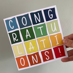 someone holding up a card with the words congratulation latti consi on it