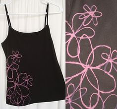 two different pictures of clothes hanging on a rack and one has a black tank top with pink flowers on it