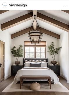 a large bed sitting under a window in a bedroom