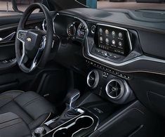 the interior of a car with black leather seats and steering wheel, dash lights, and dashboard controls