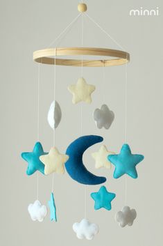 a mobile with stars, moon and clouds hanging from it