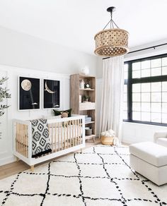 a baby's room with a crib, chair, and bookshelf