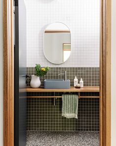 a bathroom with a sink and mirror in it