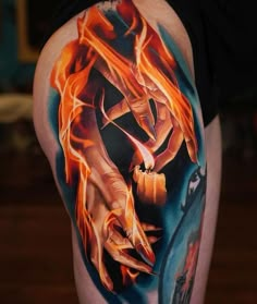 a woman's thigh with flames and hands on it