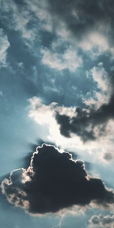 an airplane is flying through the cloudy sky