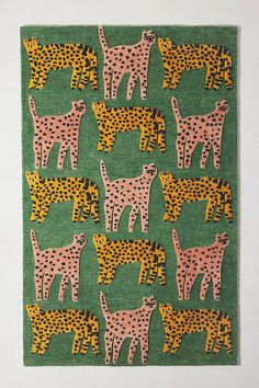 a green rug with pink and yellow cheetah on the front, black and white cheetah on the back