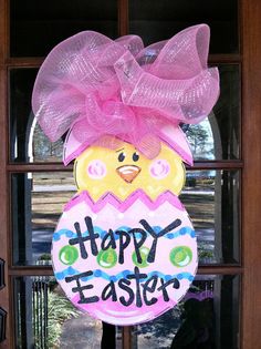 a decorated easter egg sitting in front of a door