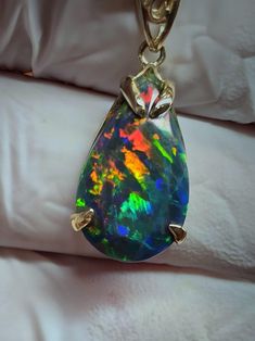 Beautiful black  opal, 12x18mm 10.23cts, 14k solid gold pendant. Teardrop fire, huge, very bright , with a  very nice floral pattern that come's out in the photographs. Very pretty in person. Opal Necklace Gold, Jewelry Opal, Necklace Opal, Necklace Black, Opal Necklace, Black Opal, Opal Jewelry, Necklace Gold, Gold Pendant