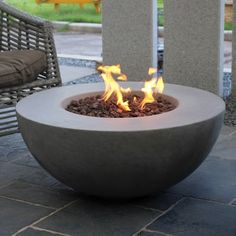 a fire pit sitting on top of a stone floor