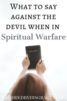 a person holding up a book with the words, what to say against the devil when in