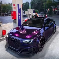 a purple car is parked at a gas station