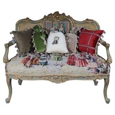 a couch with many pillows on it and an ornate frame around the backrests