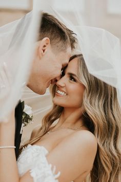 a bride and groom embracing under the veil