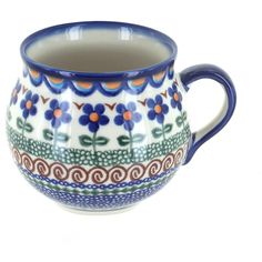 a blue and white coffee cup with flowers on the inside is sitting in front of a white background