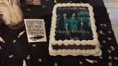 a birthday cake with the name harry potter on it next to some books and candles