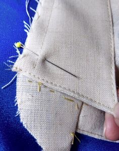 someone is stitching something on the side of a piece of cloth