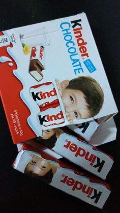 two boxes of kinder chocolate are stacked on top of each other, with the same package in front of them