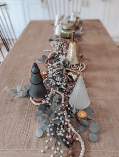 a long table with candles and decorations on it, along with other holiday decor items