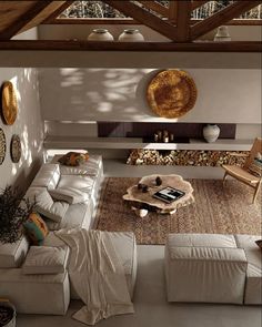 an overhead view of a living room with couches, tables and rugs on the floor