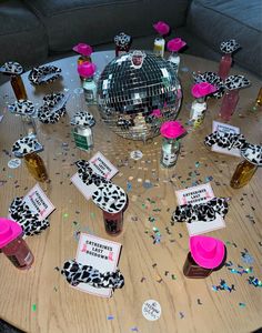 a table topped with lots of confetti and bottles on top of a wooden table