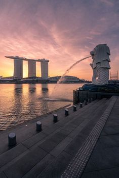 the water spewing out from its mouth at sunset