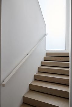 a set of wooden stairs leading up to a window