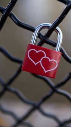 a padlock with two hearts attached to it