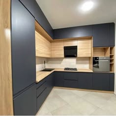 an empty kitchen with blue cabinets and counter tops