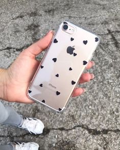 a person holding an iphone in their hand with hearts on the back and bottom case