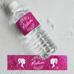 a water bottle with pink glitter labels on it