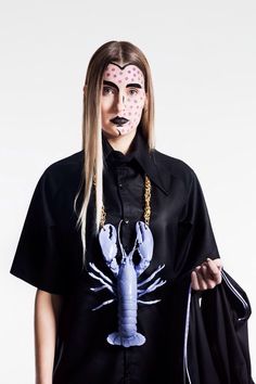 a woman with makeup on her face is wearing a lobster shirt