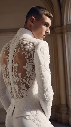 the back of a man in white wedding suit with long sleeves and lace on it