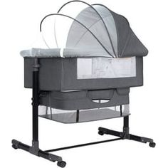 a baby crib with an infant seat attached to the back and wheels on each side