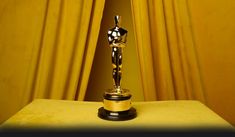 an oscar statue sitting on top of a table