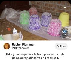 a bunch of plastic bags sitting on top of a floor next to a brick wall