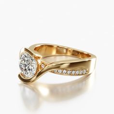 a yellow gold ring with a diamond on the top and side stones in the middle