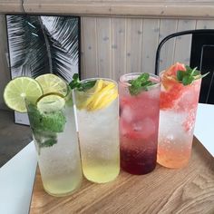 four different types of drinks are lined up on a table