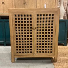 a wooden cabinet sitting on top of a carpeted floor