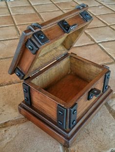 an open wooden box sitting on top of a tile floor