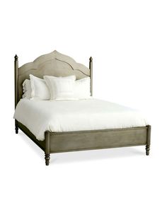 a bed with white sheets and pillows on top of it's headboard, in front of a white background