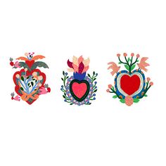 three heart shaped appliques with flowers and leaves on them, all in different colors