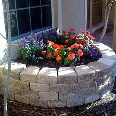 a flower bed in front of a house