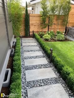 a stone path in the middle of a yard