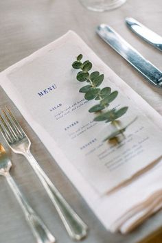 a place setting with silverware and napkins