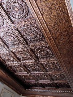 an intricately designed ceiling in the corner of a room