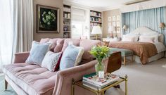 a living room filled with furniture next to a bed