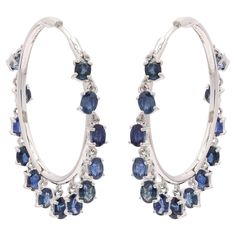 You shall need blue sapphire hoop earrings in 14K Gold to make a statement with your look. These earrings create a sparkling, luxurious look featuring oval cut gemstone. If you love to gravitate towards unique styles, this piece of jewelry is perfect for you. PRODUCT DETAILS :- > Material - 14K solid White gold > Gemstone - Blue Sapphire > Gemstone Weight - 5.9 ct > Gemstone pieces - 26 pcs > Gemstone size - 4 x 3 mm > Gemstone shape - Oval > Gross Weight - 8.757 Grams > Setting - Prong setting Sapphire Hoop Earrings, Vintage Rhinestone Earrings, Gemstone Hoop Earrings, Starburst Earrings, Platinum Earrings, Blue Sapphire Gemstone, Modern Blue, Moonstone Earrings, Diamond Drops