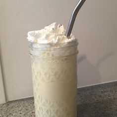 a glass jar filled with whipped cream and a spoon