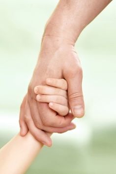 two people holding each other's hand while they hold their hands in the air