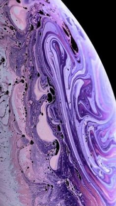 the back side of an iphone with purple and blue swirls on it's surface